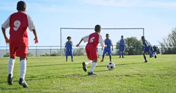 Youth soccer players competing in a match on the field